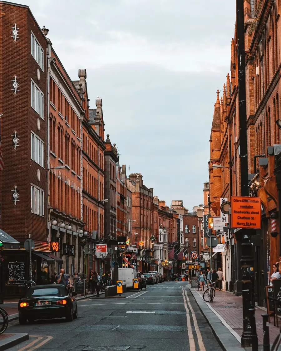 A Dublin street lined with red-brick buildings and marked delivery lanes