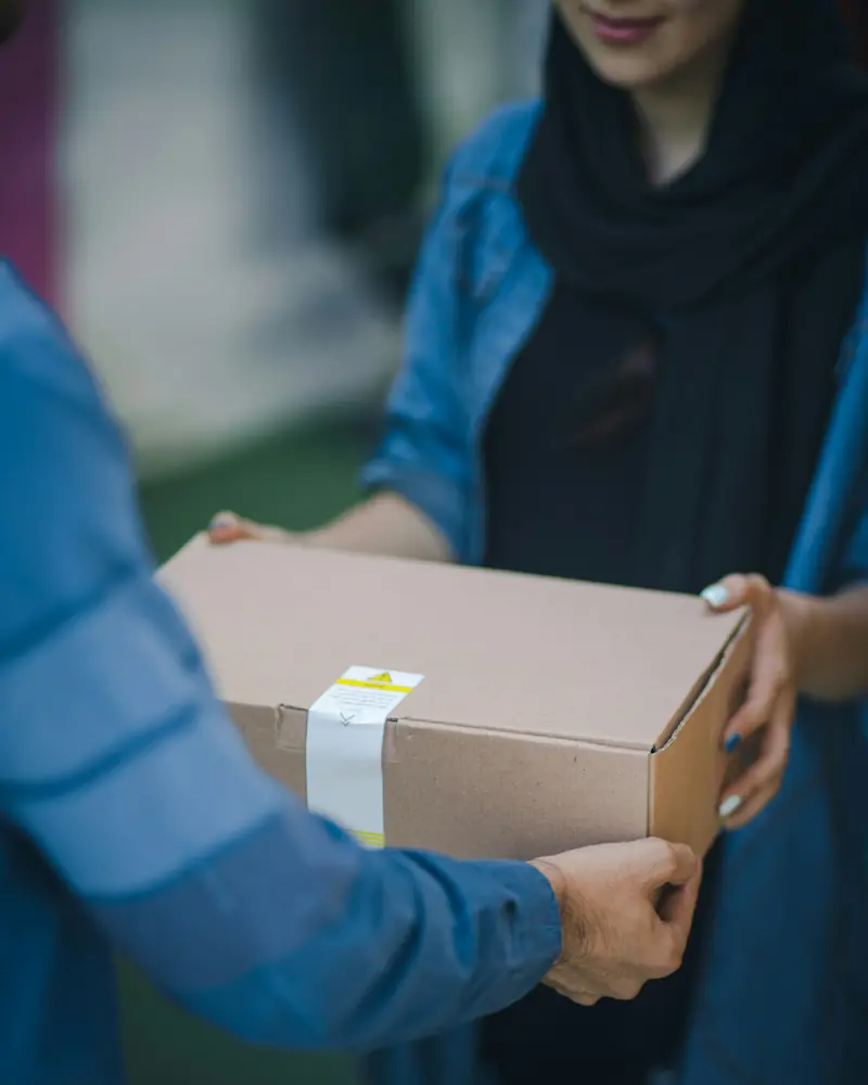 A parcel being handed over at the point of delivery